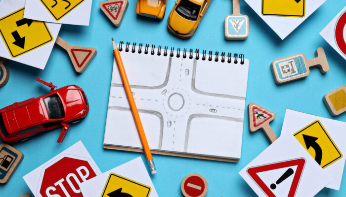 Road signs and vehicles on a blue background.